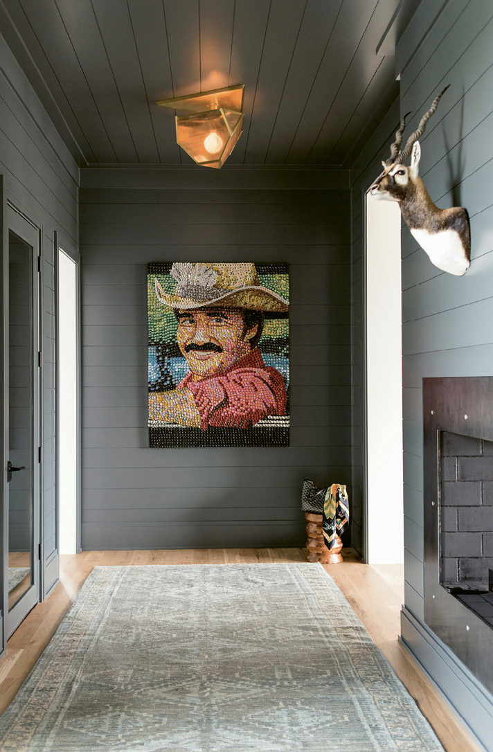 Farrow &amp; Ball’s “Down Pipe” covers shiplap in the foyer with its Smokey and the Bandit bottle-cap painting