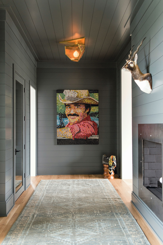 A colorful bottlecap of Burt Reynolds in Smokey and the Bandit by local artist Molly B. Wright playfully invites visitors into this stylish Daniel Island residence, a reader favorite that we first published in July 2019.
