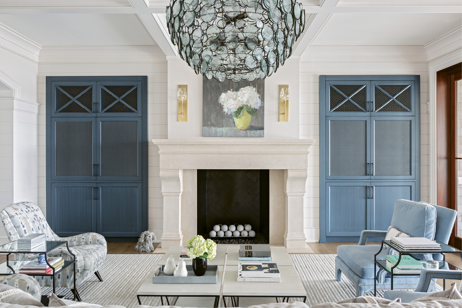 Hundreds of glass circles in the Currey and Company chandelier play with the ever-shifting light outside. A large oil painting by Barbara Flowers highlights the living room. The striking work of white hydrangeas captivated Suzie the moment she saw it in the window of Principle Gallery in Charleston.