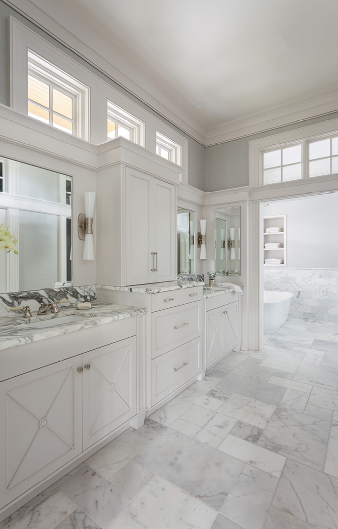 Strategically placed windows in the master bathroom bathe the marble tile in natural light without compromising privacy.