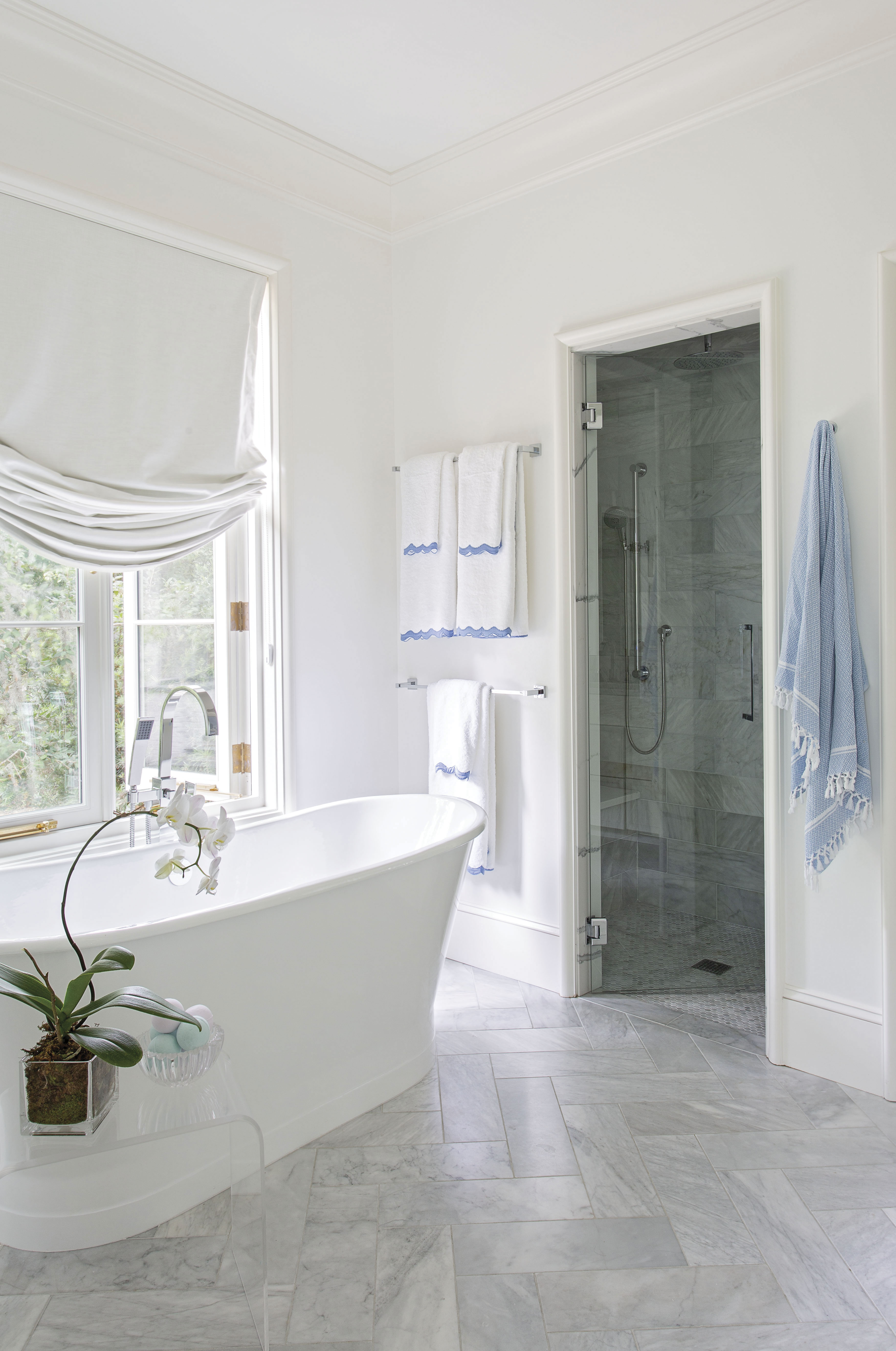 The en suite bath’s sculptural soaking tub and striking marble tiled floor.