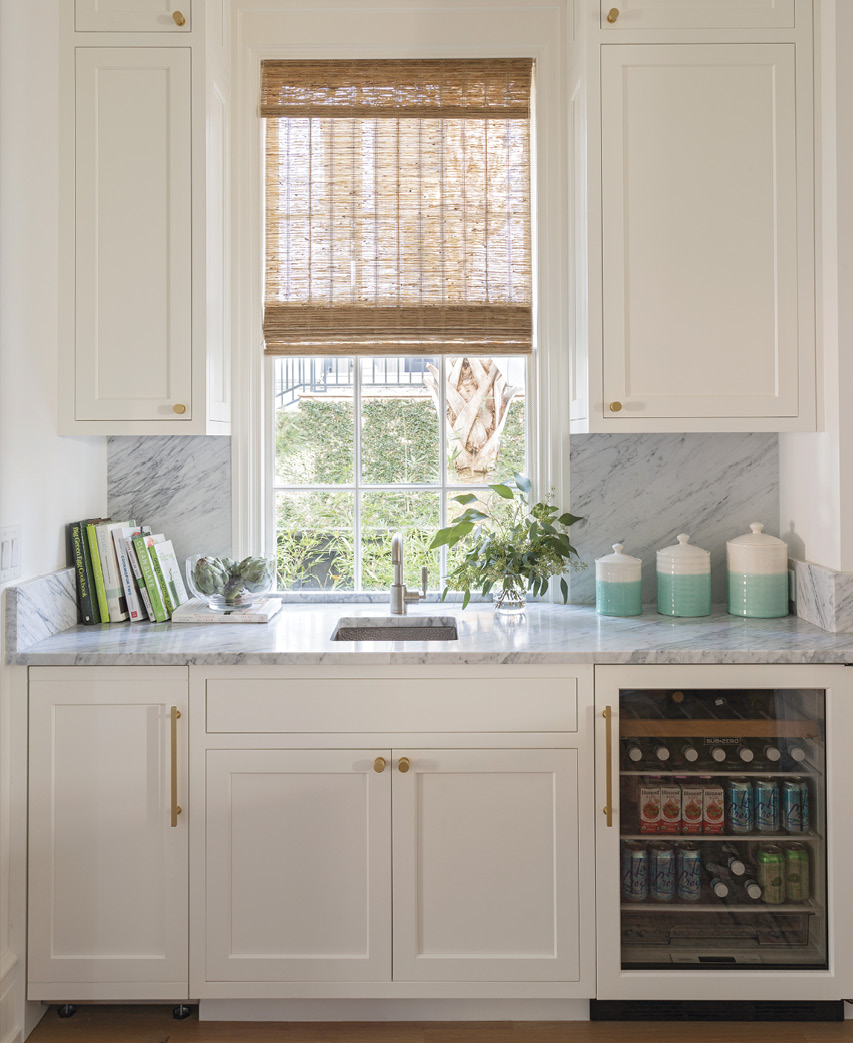 Cabinets by Hostetler Custom Cabinetry with Carrara marble tops continue the bright, light theme