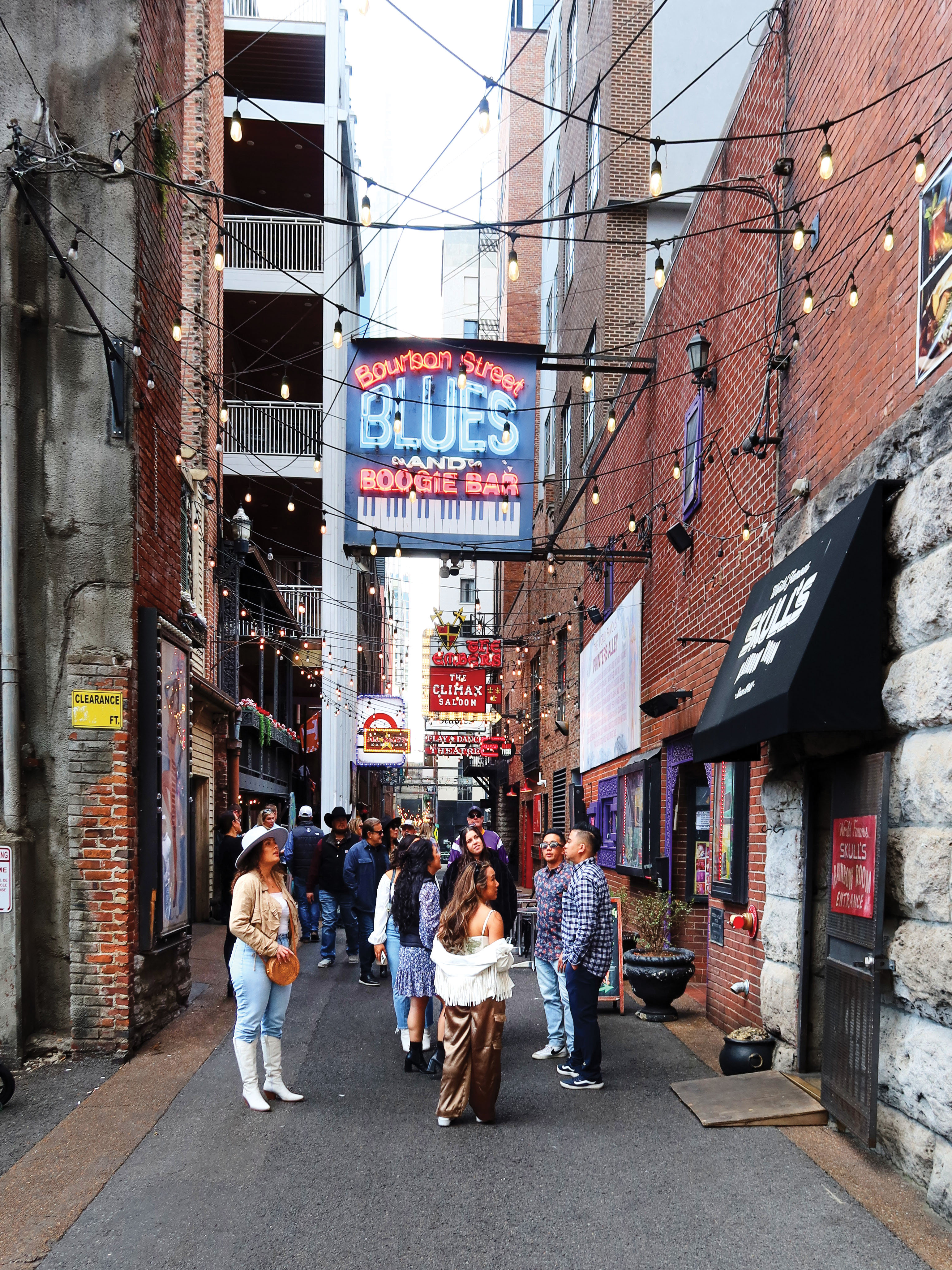 Printers Alley near Broadway, home to honky-tonks, neon lights, and live music.