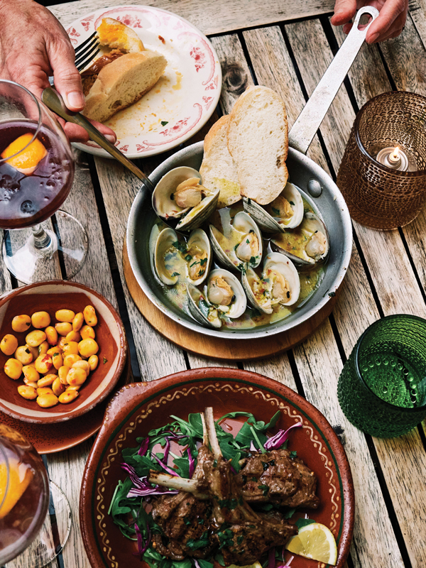 Pitchers of sangria, clams in a garlic-herb broth, marinated lamb chops, and lupini beans at Aguardente, a new addition to a Providence neighborhood that’s been home to Portuguese immigrants for centuries.