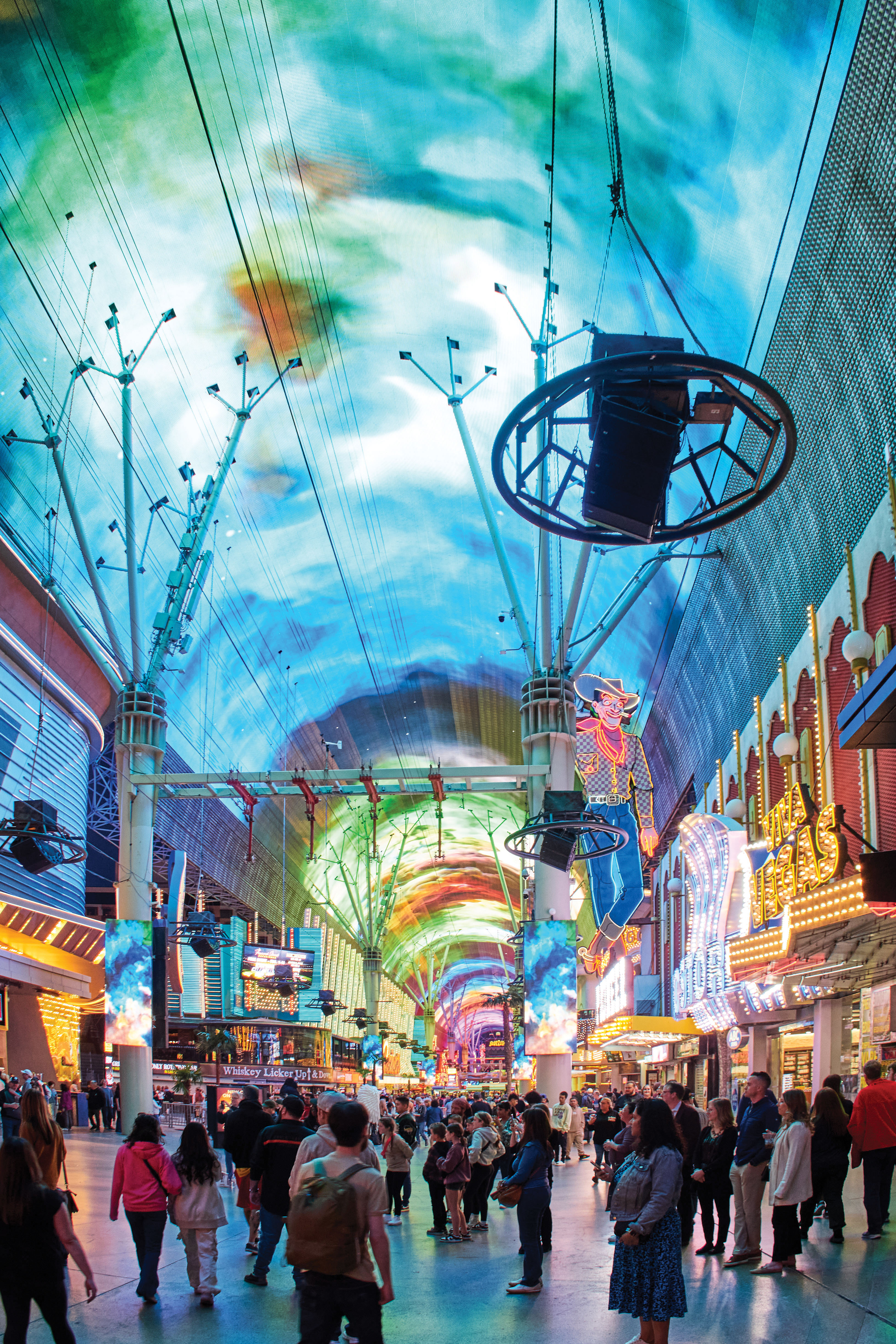 Electric Avenue:Nostalgic “old Vegas” on Fremont Street, now domed and closed to cars; crowds gather here around street performers while signs glow overhead.