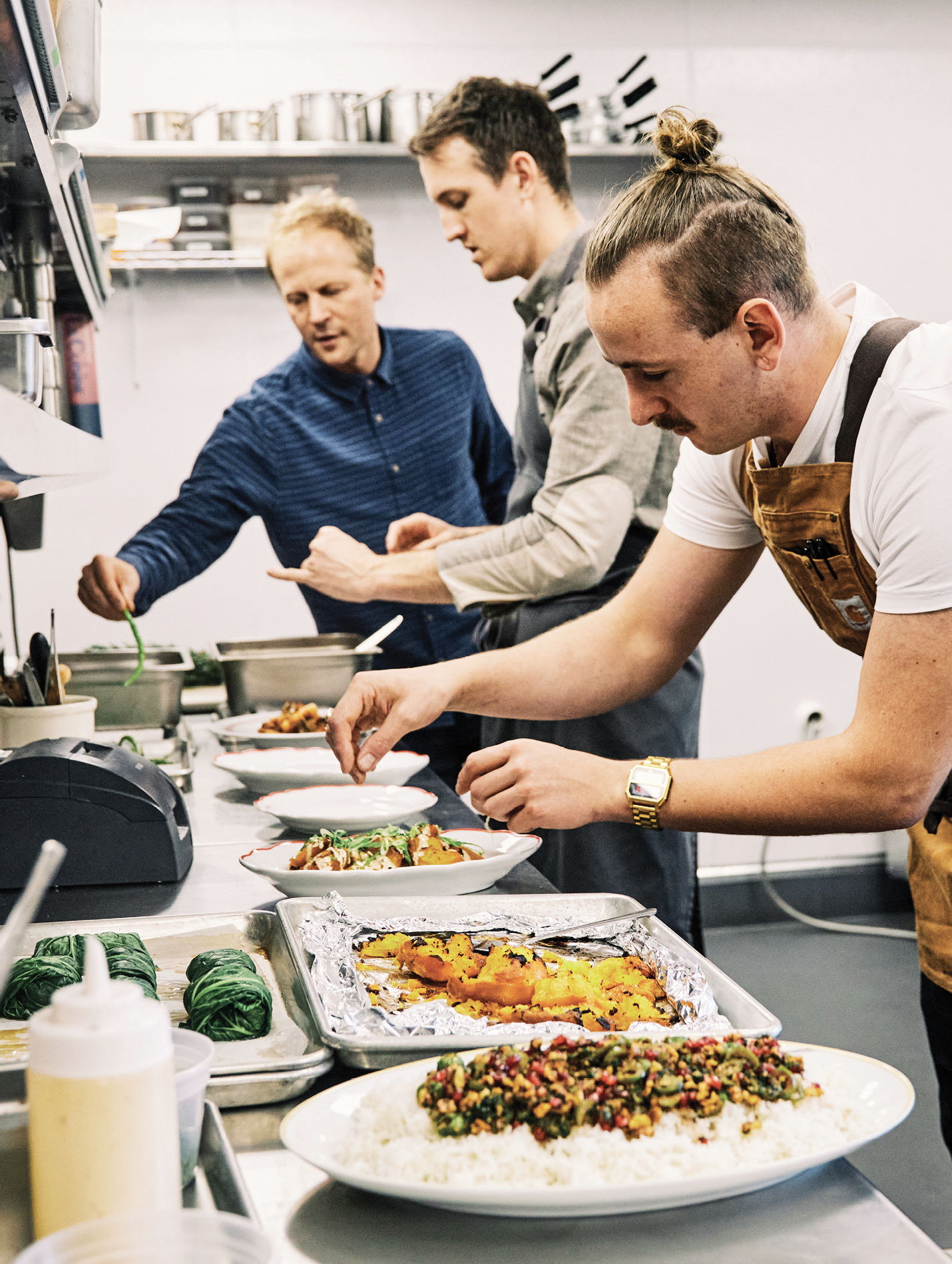 The chefs at Basic Kitchen (Charles Layton, right) and Post House (Evan Gaudreau, center) have their own culinary styles, yet both are aligned with Ben’s focus on elevating fresh, wholesome ingredients.