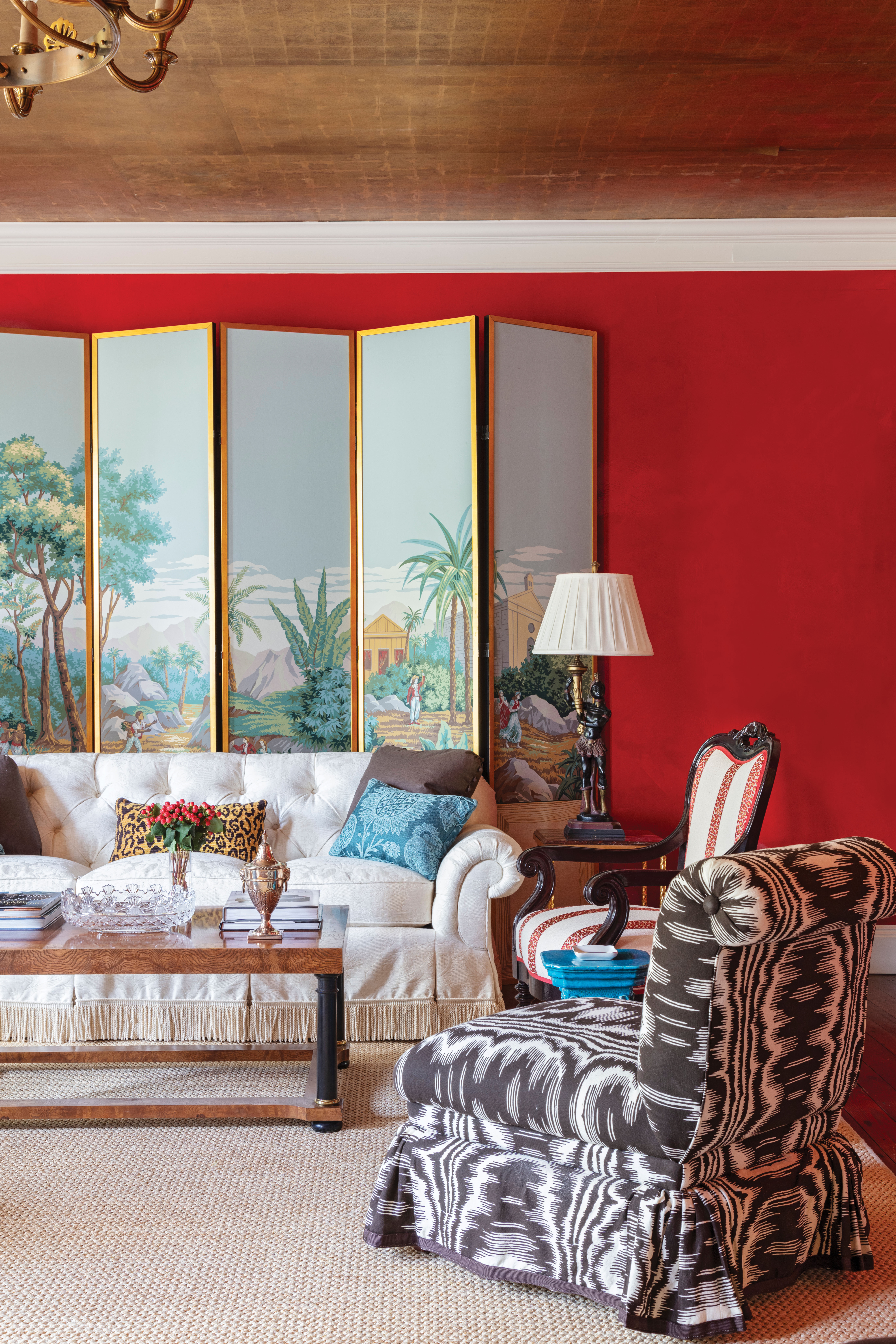 Killian balanced the bold space with geometric monochrome curtains in Raoul Textiles “Amore” fabric in “Mole,” chocolate velvet sofas trimmed in Lee Jofa bullion fringe, and vintage elephant side tables from Palm Beach.