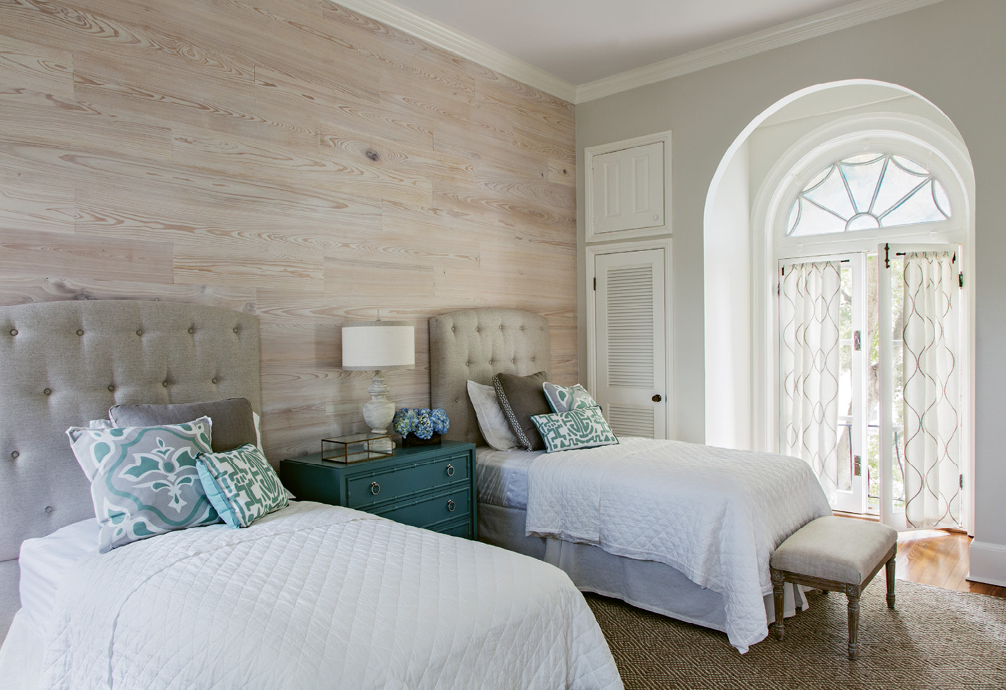 The guest bedroom features an accent wall of whitewashed cypress.