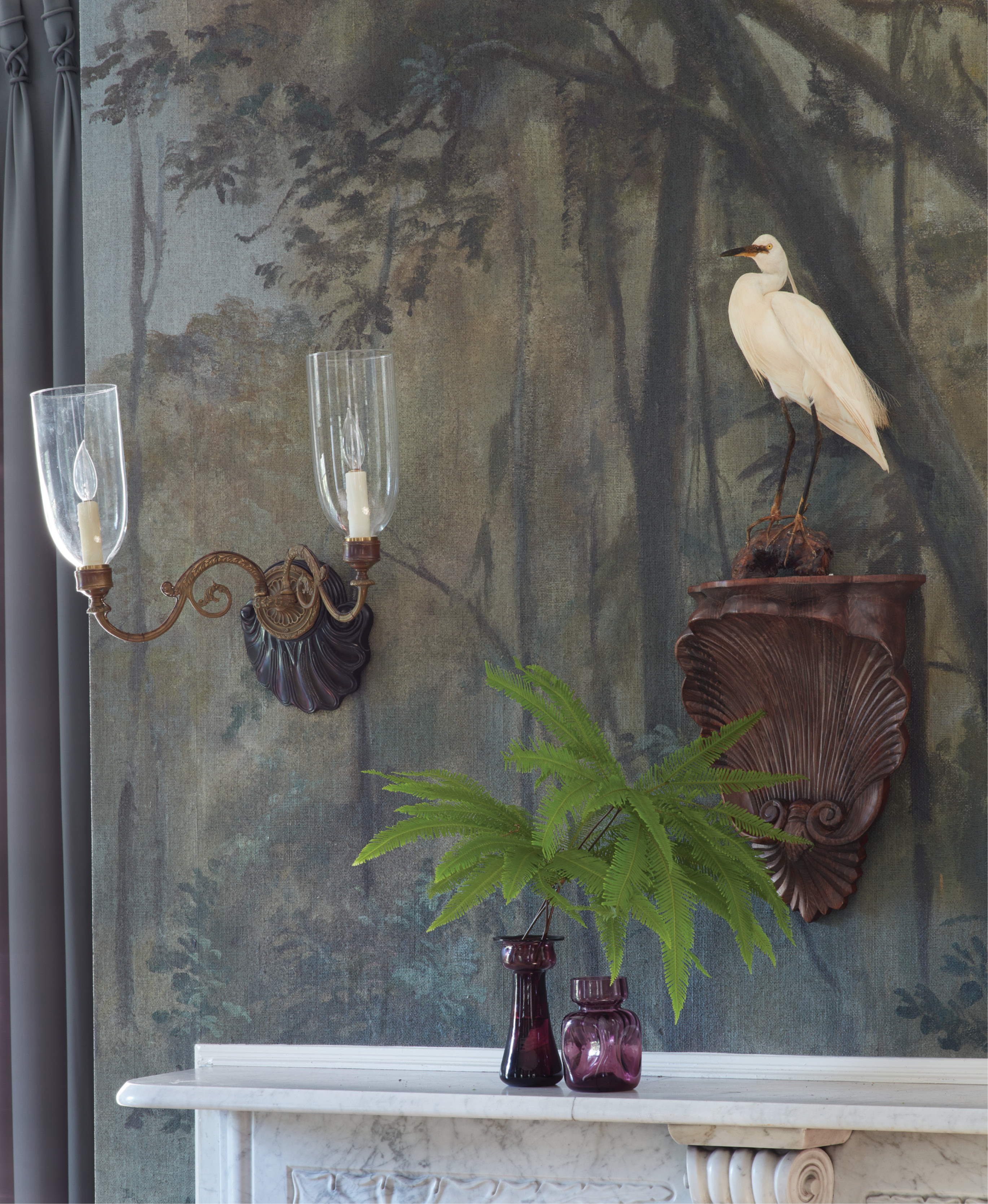 This hand-painted mural of a cypress swamp by artist Raymond Goins provided a unique starting point for a thoughtful re-imagining of an 18th-century single house’s dated interiors.