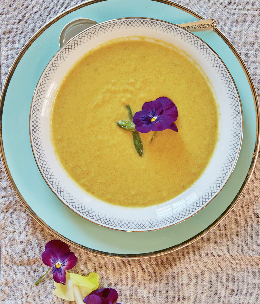 Garlic, veggies, and grated cheese are blended in creamy asparagus soup.