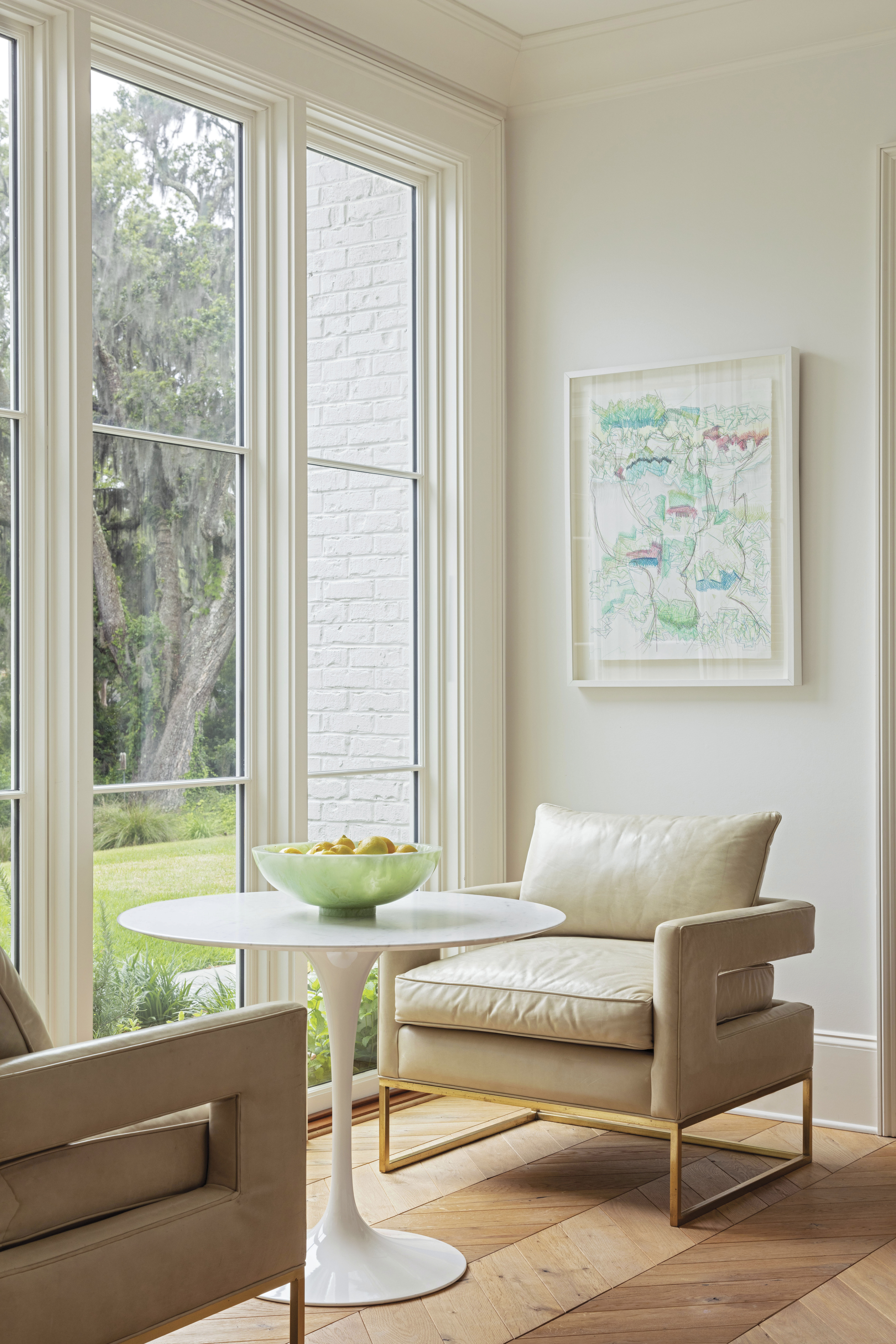 The garden room in the hyphen between the kitchen and the main home creates a nice pause, as well as a spot to soak up the view on vintage chairs paired with a Knoll “Saarinen” table.