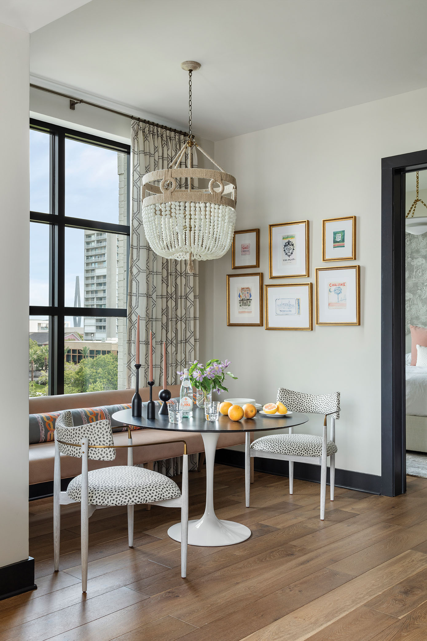 breakfast with a view: The small dining nook offers views of the Ravenel in the distance. A fun chandelier from Ro Sham Beaux above a Knoll tulip table adds whimsy.