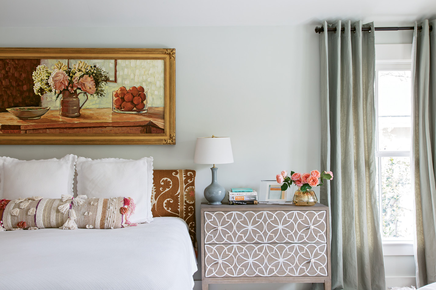 In the master suite, a Russian impressionist still life complements the Suzani embroidered headboard.