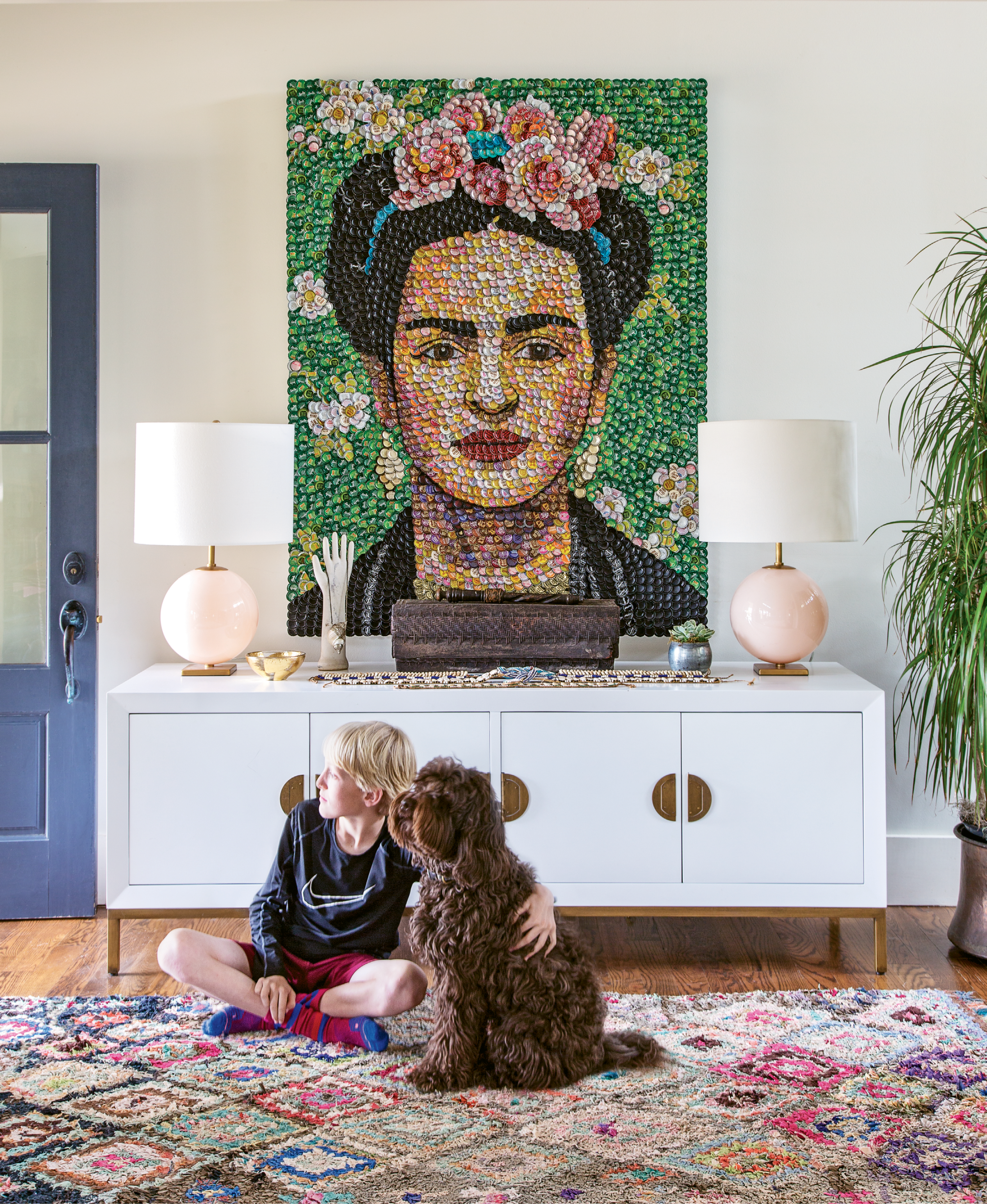 Captivating Entry: Colorful and joy-filled artwork, like this bottle-cap portrait of Frida Kahlo by area artist Molly B. Right, jives well with the Williamsons’ lively home, as does the open floor plan. “The boys are so dynamic; the level of activity here is insane,” says Allison.