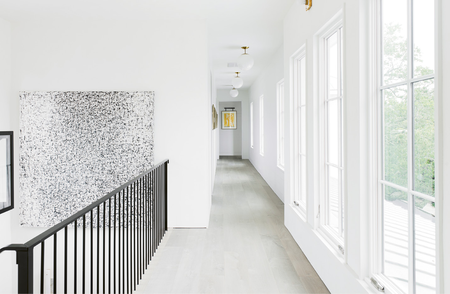 A custom black-and-white piece by Belgian artist Sabine Maes makes a statement in the upstairs hallway.