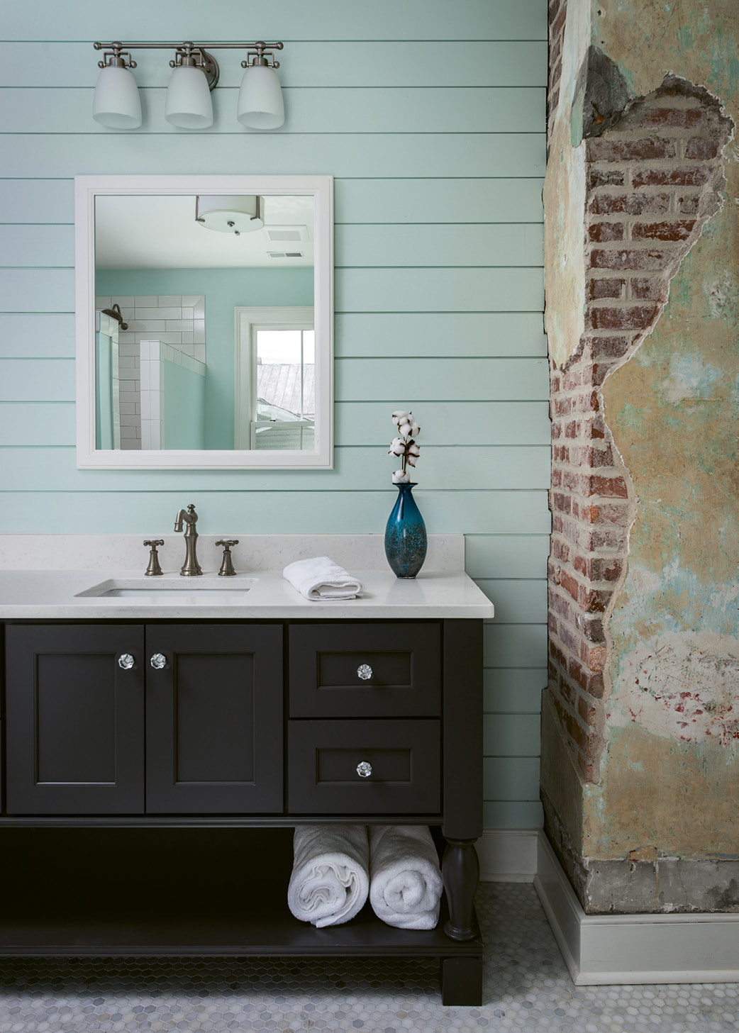 When Engelke’s crew had trouble removing all the plaster from the brick column in the master bath, Cindy decided to embrace it. She’s come to love the patina it adds to the space.