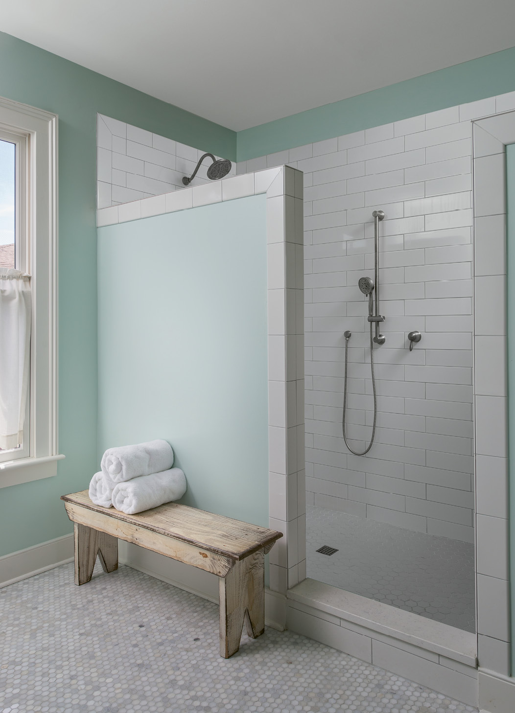 A tiled shower with no glass door makes the bath low-maintenance. “The design is a result of me hating to clean glass doors; I never wanted to see another squeegee again!” Cindy laughs.