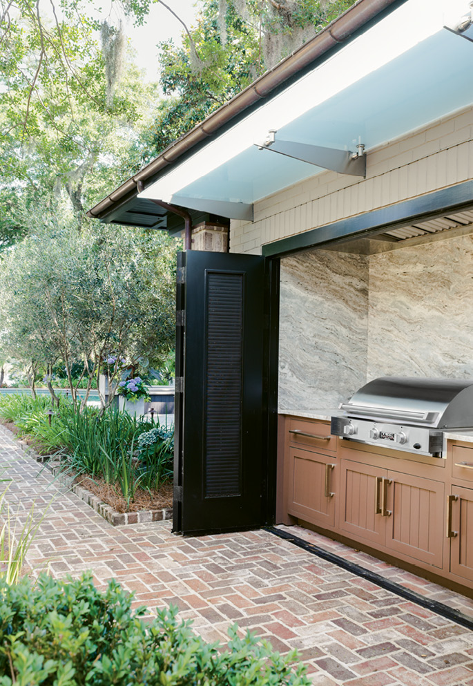 Fired Up: An outdoor kitchen makes grilling effortless for poolside dining.