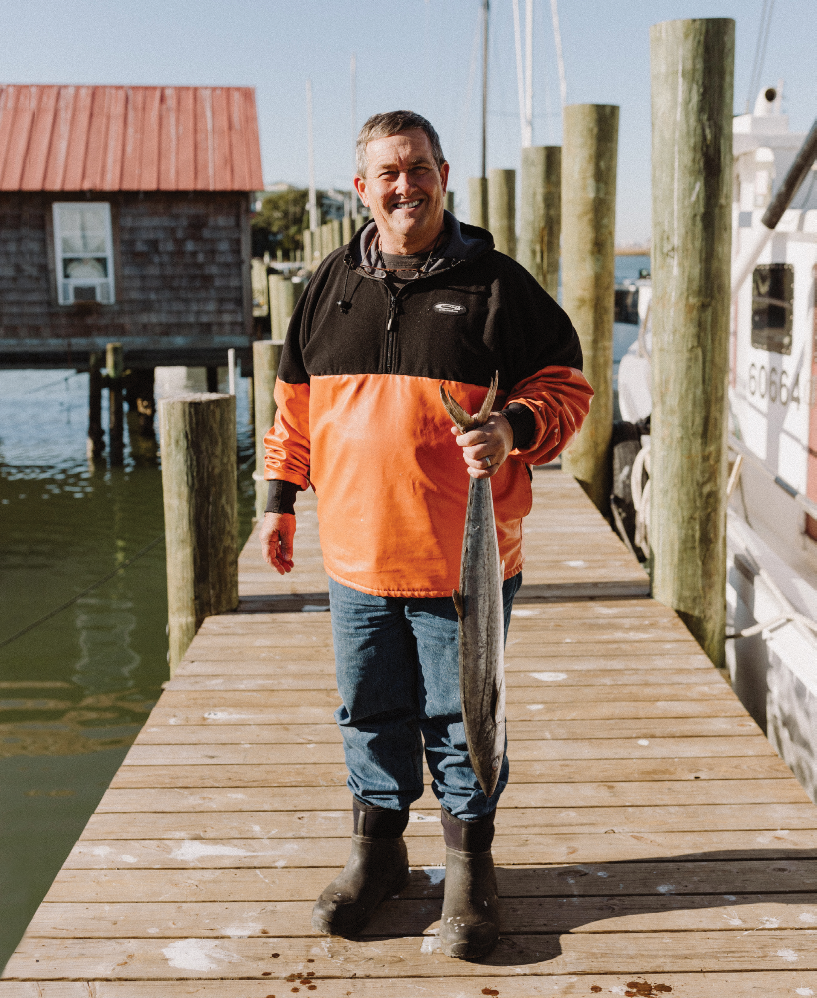Local fisherman and Abundant Seafood owner Mark Marhefka with a king mackerel on Geechie Dock at Shem Creek
