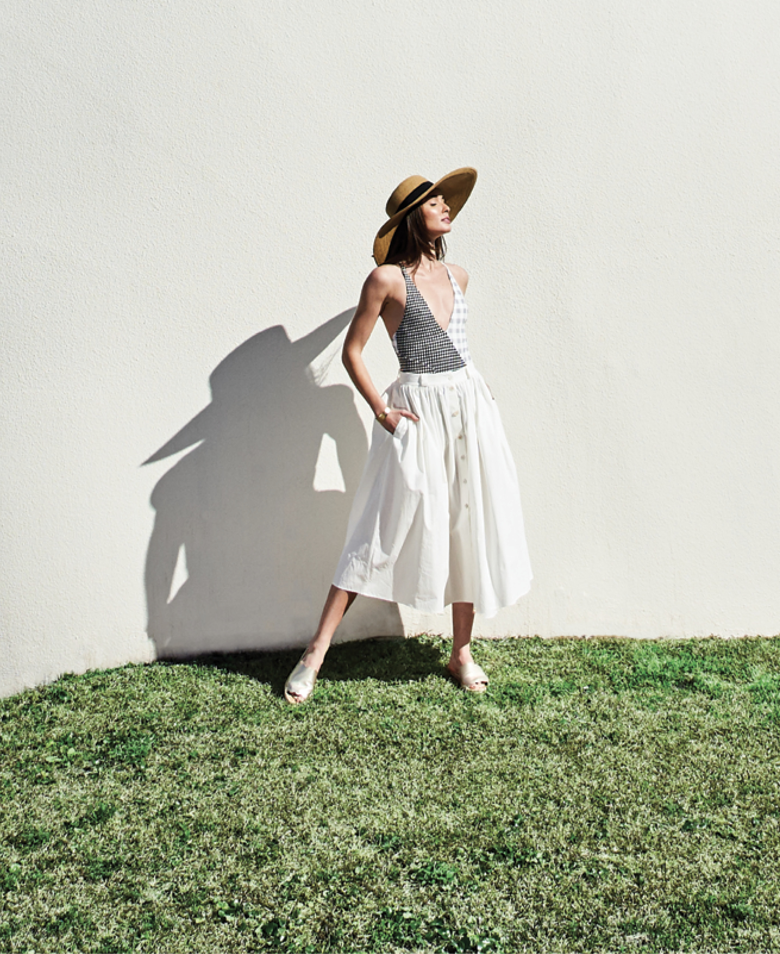 SUIT UP - Marysia “Suffolk Maillot,” $359 at Everything But Water; Brock Collection cotton “Olivo” button-up skirt, price upon request at RTW; Gretchen Scott sun hat, $59 at Gretchen Scott; Kendra Scott “Tenley” 14K gold-plate cuff, $95 at Kendra Scott; Sam Edelman “Andy” leather slide in “light gold,” $90 at Shoes on King