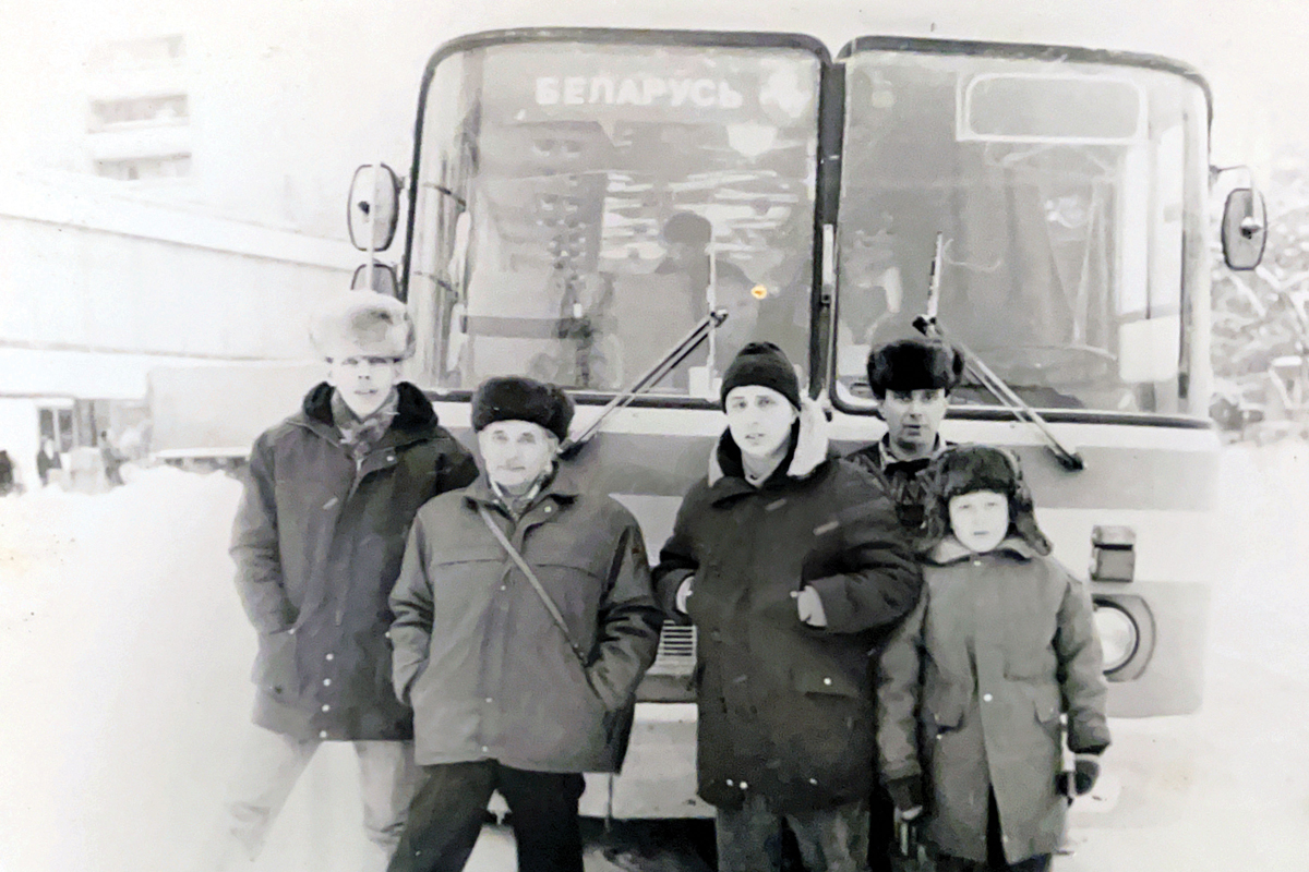 Like many Russian Jewish families in the early 1990s, the Bekkers left Russia, chartering a bus to the airport in Moscow to avoid thieves preying on the immigrants. Getting on the bus, a 10-year-old Yuriy is on the far right.