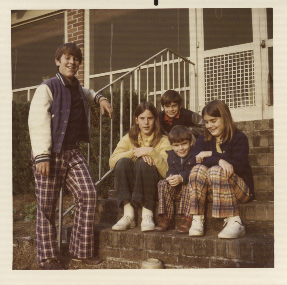 Julian standing with four of his siblings on the steps of their North Shore Drive home