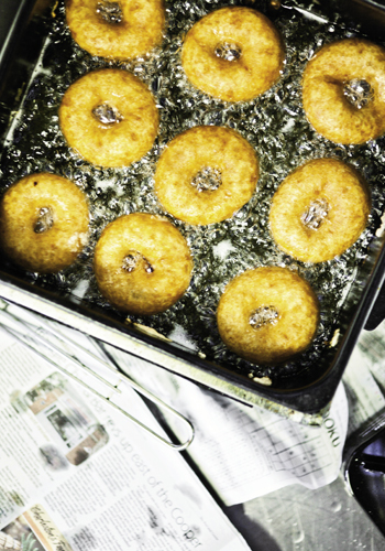 A batch of hot-out-of-the-oil vegan doughnuts