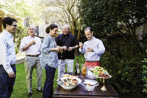 Matt (right) mixes up some Kumquat Sparklers for (from left) Simons, Rutledge, and Sarah Moïse Young and her dad, Ben. Snacks that await on the table include the highly addictive “Henry’s Cheese Spread,” which was served alongside crudité on every table of the famed Charleston restaurant Henry’s; stone crab claws from the Stono River with “Ashley Avenue Bay Butter;” and spiced pecans from a fall Chalmers Street harvest. (inset) Hosts Kathleen and Rutledge Young.