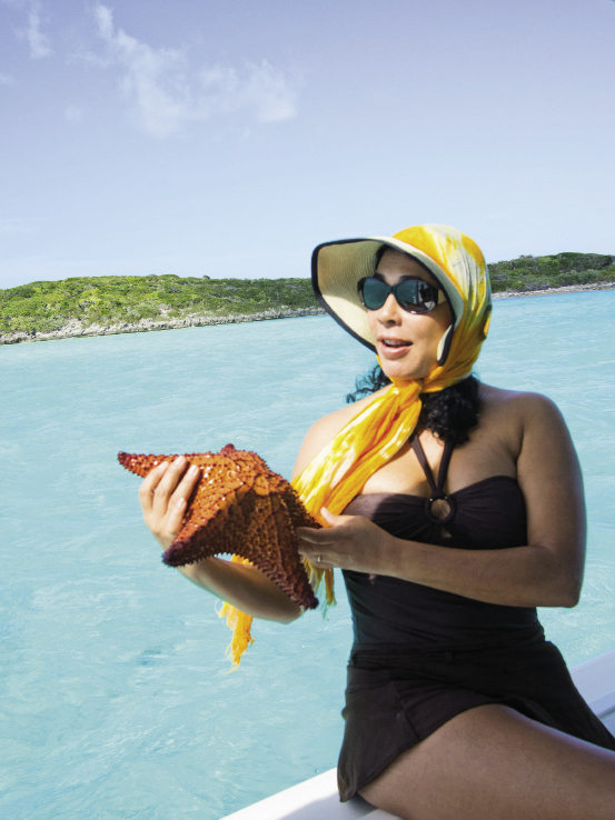 A passenger holds a bony starfish before it’s returned to the ocean