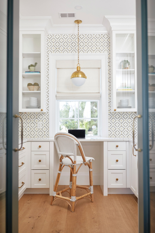 A ROOM OF ONE’S OWN: Just off the kitchen, hidden behind two doors integrated into the cabinetry, a butler’s pantry featuring Tabarka handmade terra-cotta tile doubles as Emily’s home office.