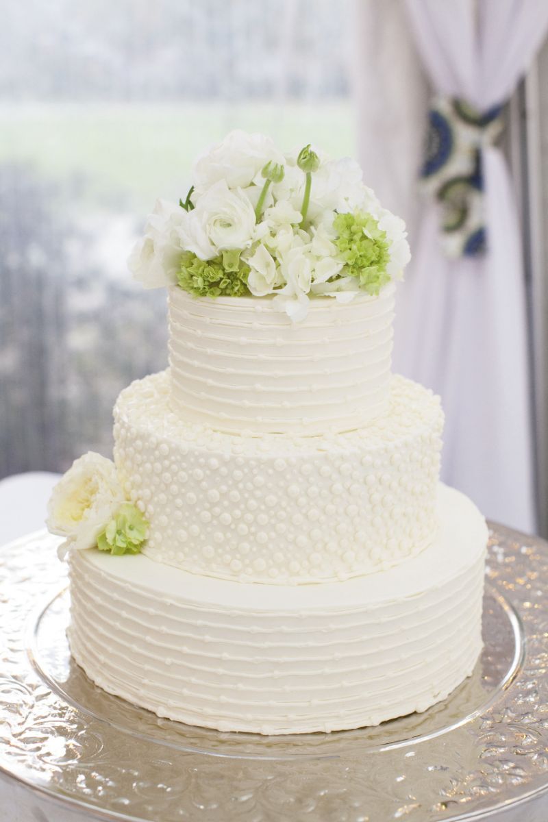 TONE ON TONE: The stripes and dotted designs throughout the wedding took a subtle turn when iced in white on the wedding cake by Fish Restaurant.