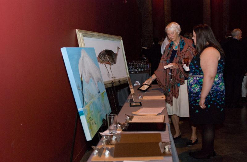 Attendees examine silent auction items