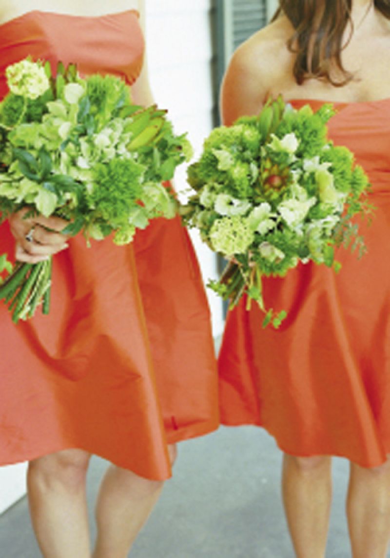 ORANGE CRUSH: Bridesmaids donned bright frocks by Jim Hjelm and held springy bouquets of bupleurum, green trick, helleborus, hydrangea, leucadendron, and viburnum.