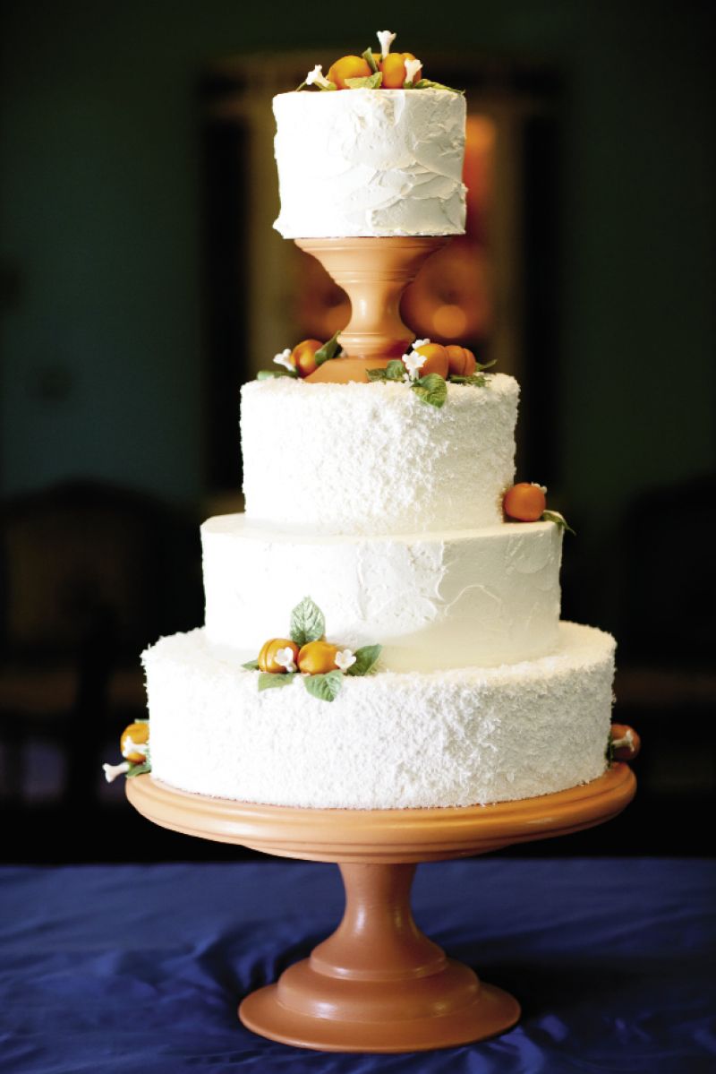 SUGAR HIGH: Wedding Cakes by Jim Smeal frosted the cake with two different icings—stuccoed buttercream and natural white coconut—then garnished the treat with marzipan apricots.