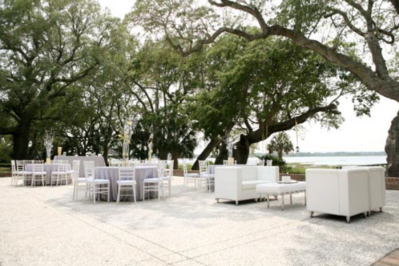WIDE OPEN SPACES: The terrace at Lowndes Grove overlooks the Ashley river; the oyster tabby suited the pale gray and white reception furniture in sublime fashion.