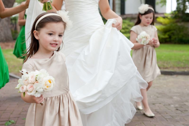 WALK THIS WAY: The flower girls, in champagne-hued frocks and headbands from J.Crew, were armed with mini versions of Jessica’s bouquet by Heather Barrie of Gathering Floral + Event Design.