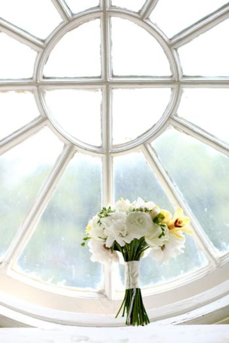 PRETTY AS A PICTURE: A top-floor window in the mansion is a great perch for brides and bouquets alike to pose for portraits.