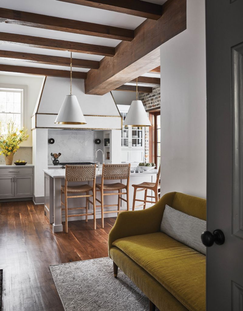 Gathering Place: Berry and the homeowners  completely remodeled the kitchen, incorporating  a striking plaster hood, also by Kollar, and adding more beams to balance the ceiling.