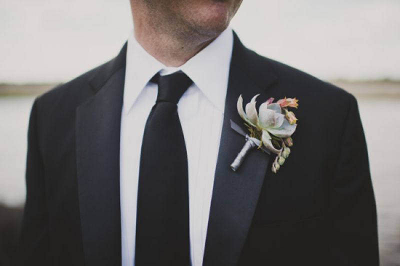 DAPER DECORATION: Jason’s boutonniere, a succulent fashioned by A Charleston Bride, popped against his classic J. Crew tuxedo.