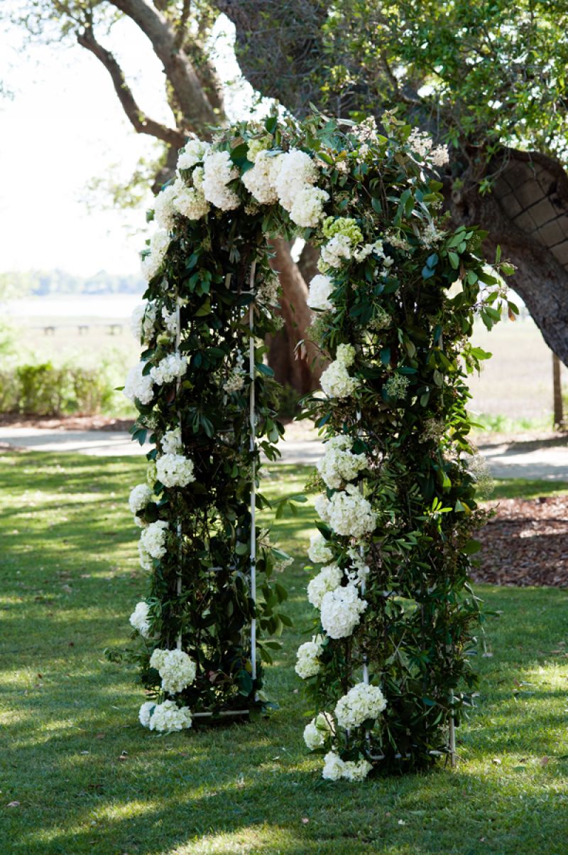 GREEN GARDEN: The couple exchanged vows beneath a trellis dressed in hydrangea and fresh vines.
