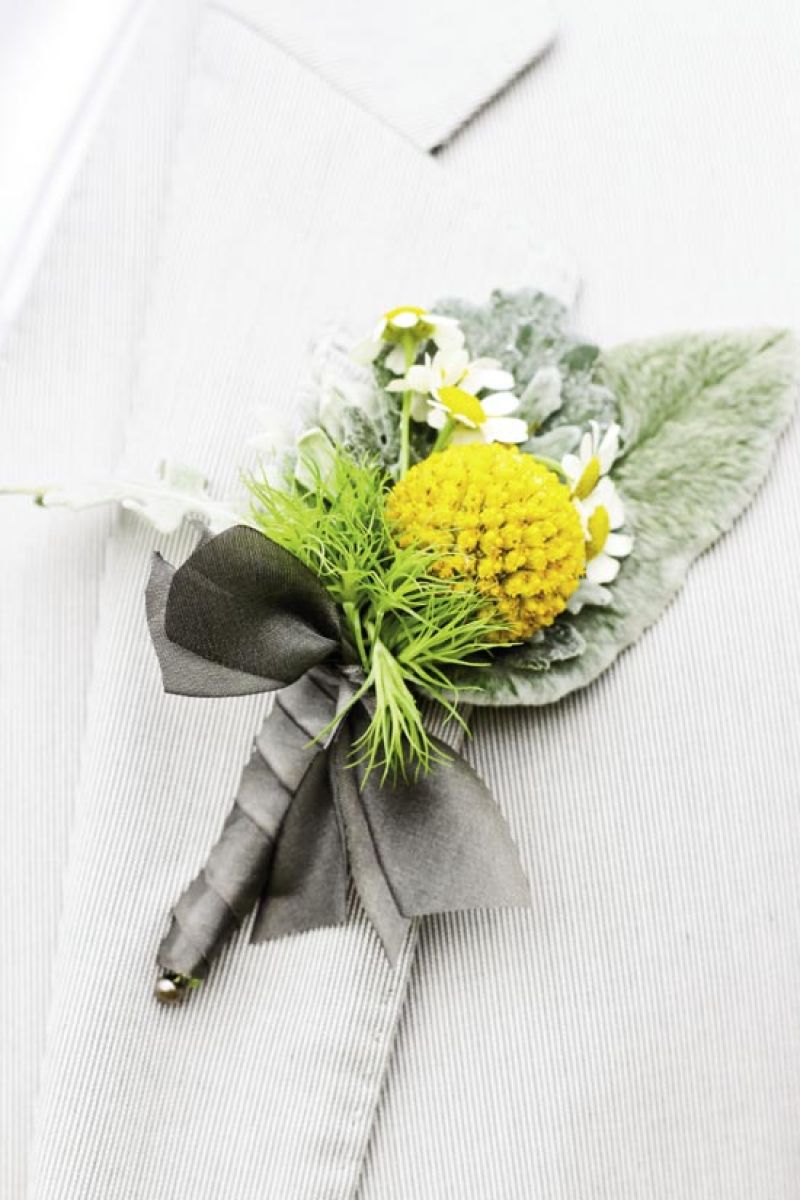 MARK OF A GENTLEMAN: Out of Hand made boutonnieres of Billy Balls, daisies, and greens.