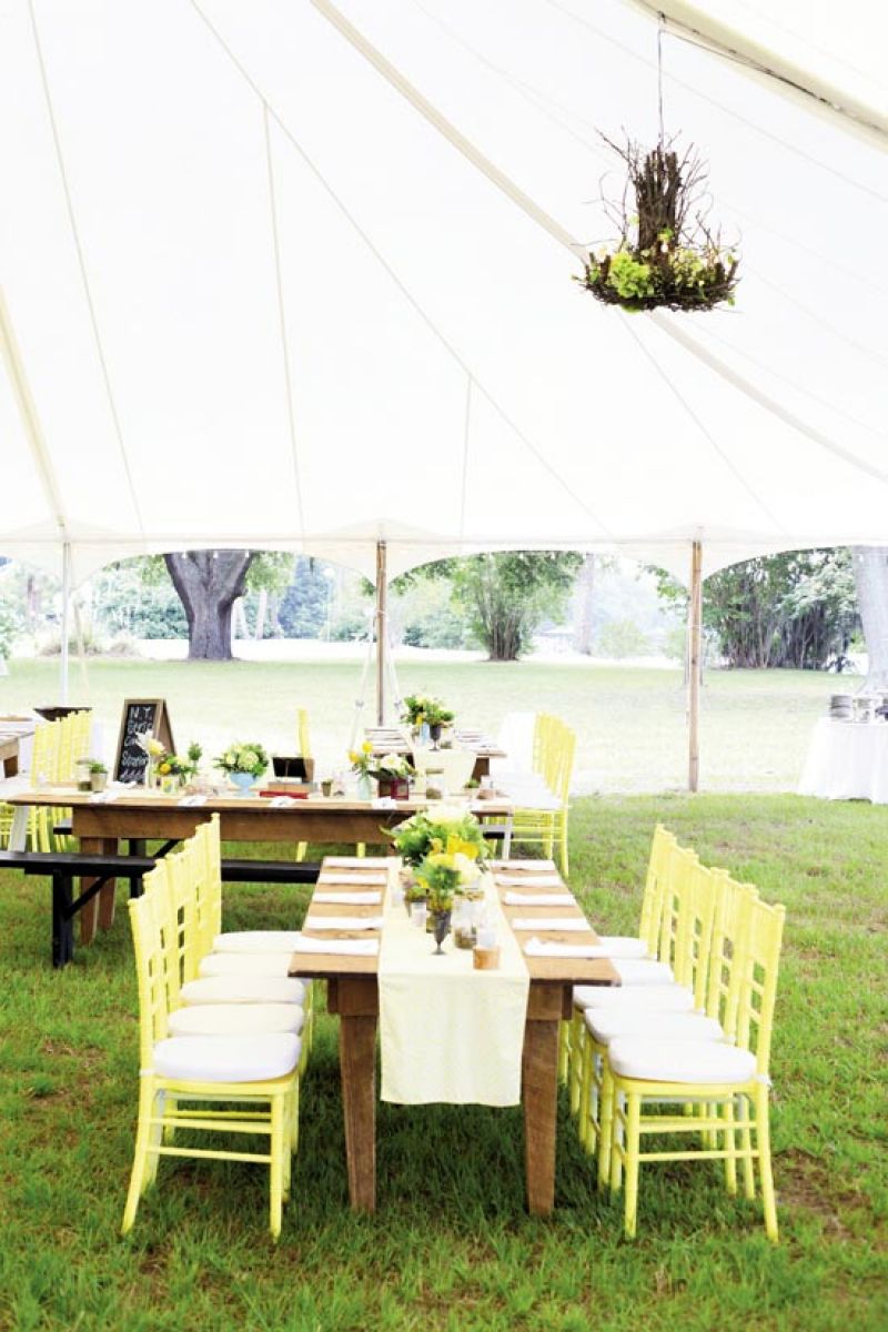 COLORFUL STORY: Carrie spotted her dream palette of yellow, gray, and blue in a wedding magazine, so Jonny contacted the featured couple to get their Pantone colors. The rented chairs were custom-painted to suit her vision.