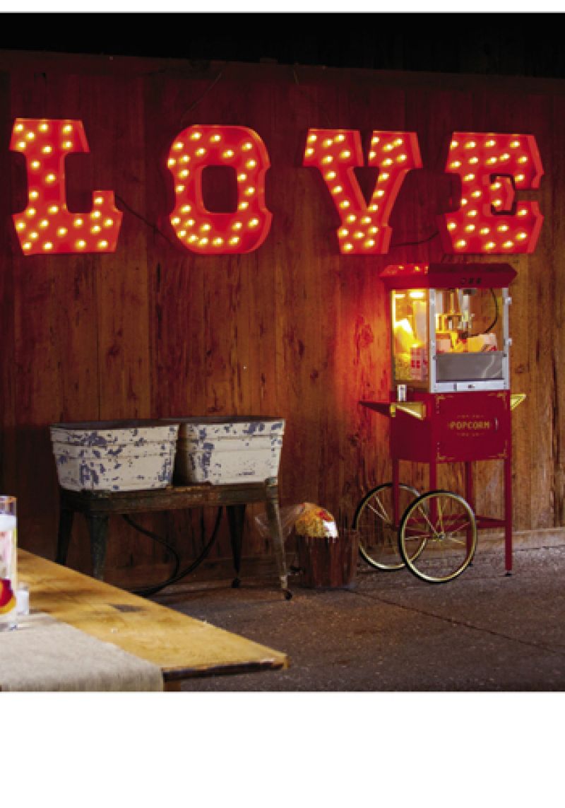 PING QUEEN: Mary rented most of her décor, like a  vintage popcorn machine, from Ooh! Events. Perhaps her favorite score? The red, lighted “LOVE” sign, which was a surprise donated element from the gals at Ooh! Events.