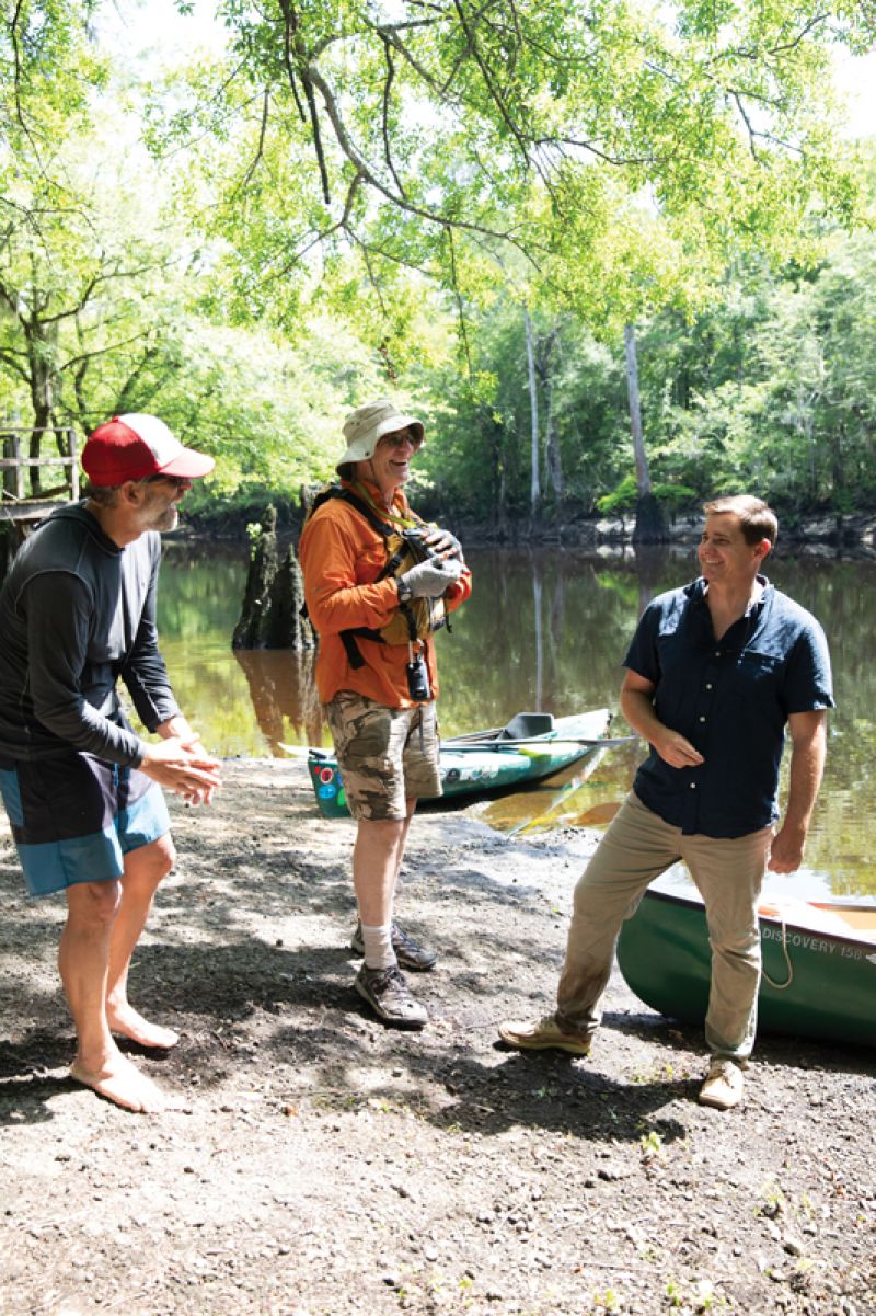 Coverdale, Drucker, and park project manager Nick Wallover swap jokes during a break from paddling.