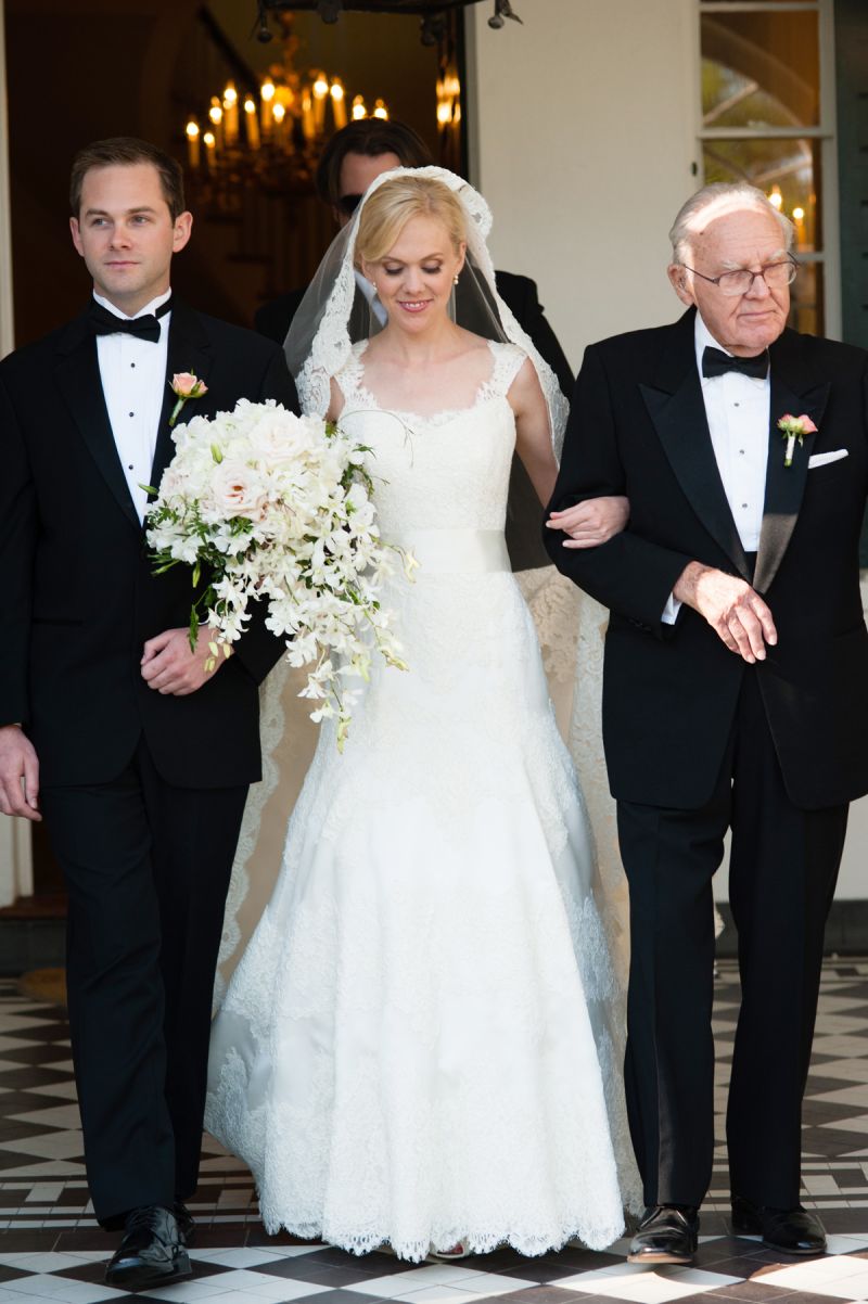 BLUSHING BRIDE: Anna, who was escorted down the aisle by her brother and grandfather, carried a bouquet of white and pale pink r