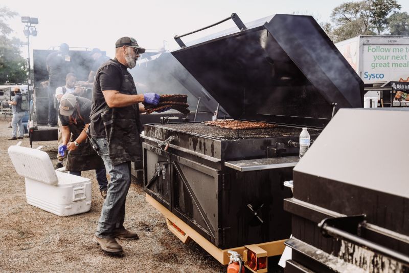 Pitmaster Anthony DiBernardo tends to ribs in the Traditional Village.