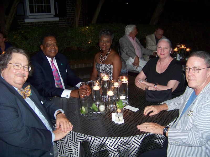 A group of patrons chats in the moonlight.