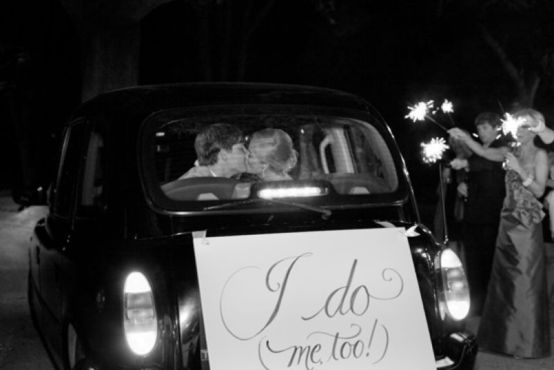 HAPPILY HITCHED: Tyler and Danny rode away in a vintage sedan rented from the Charleston Black Cab Company sporting a custom-made sign.