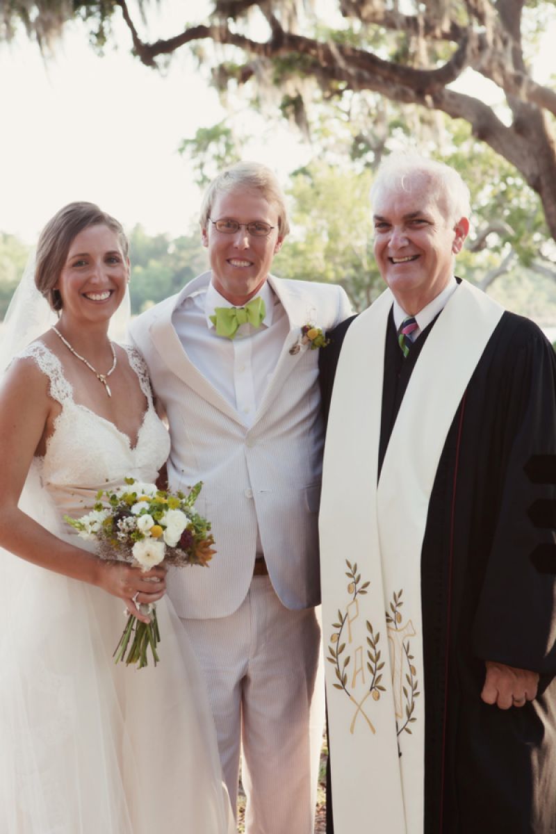 MR. &amp; MRS.: Lindsey and Christopher give off a newlywed glow posing for a picture with the officiant.