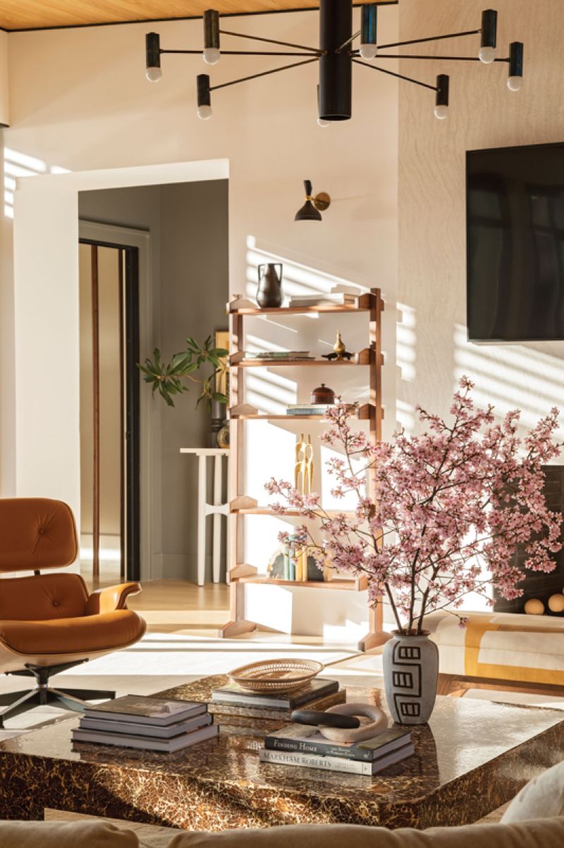 The Light Fantastic: The play of light in the home is part of the design, highlighting intentional, uncluttered pieces such as the custom walnut bookcase by Spiridon. The sculptural Lumfardo chandelier adds contrast.